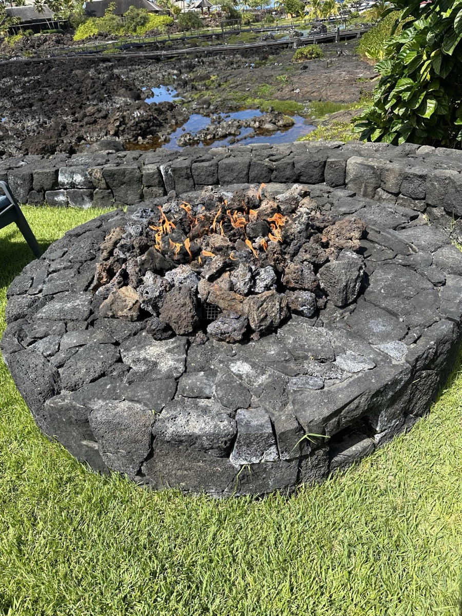 Luxury patio with lit fire pit and seating